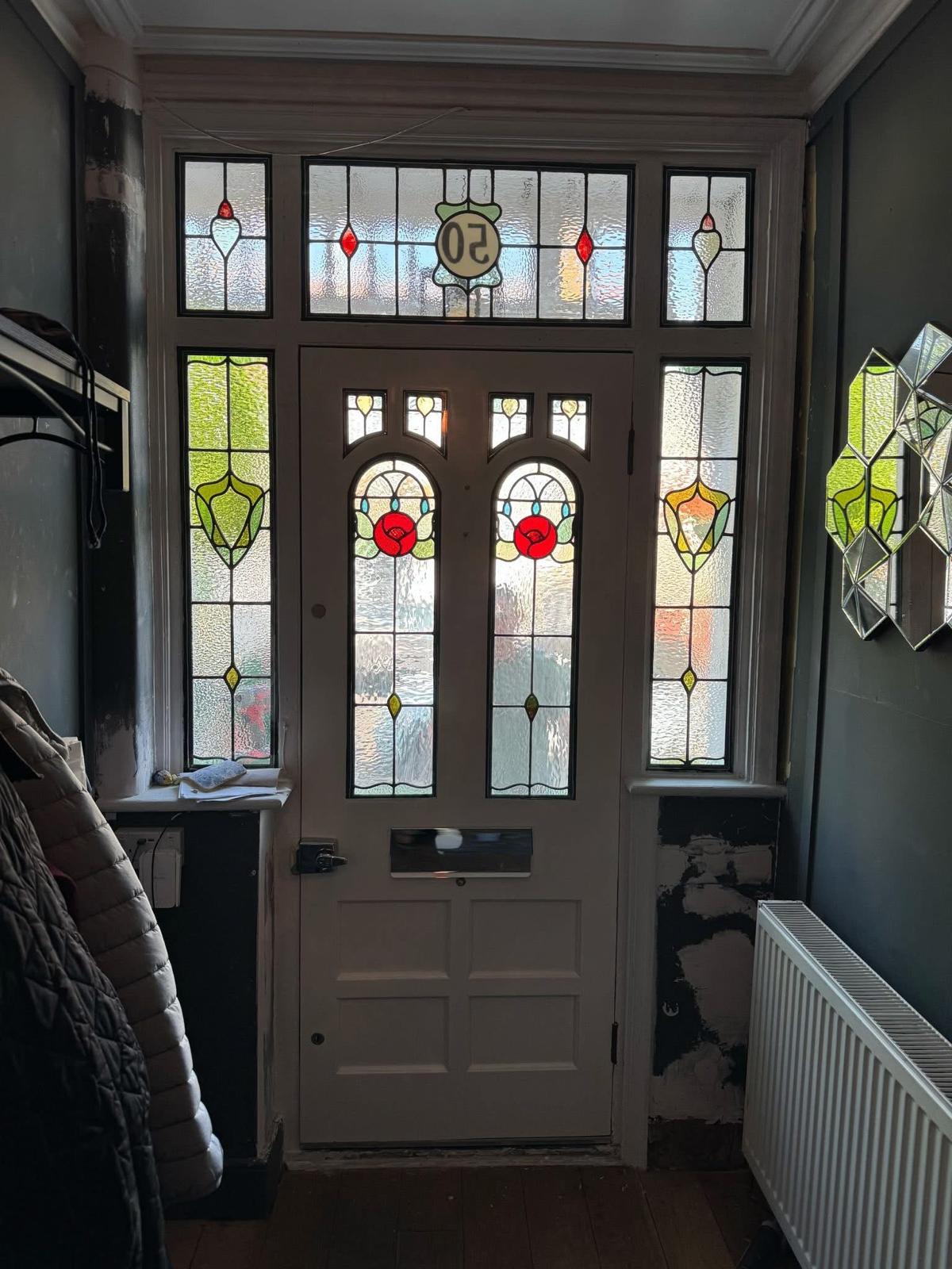 Before and after of a panelled front door stripped of layered paint and refinished at the Double Dipper workshop in Yorkshire